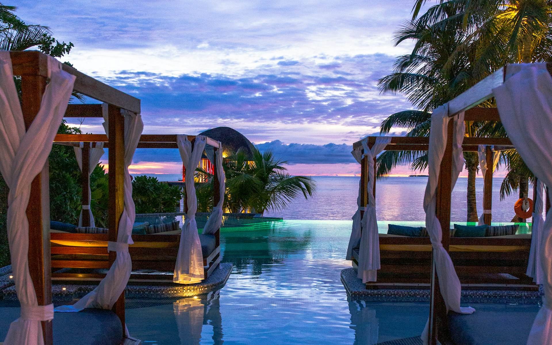 Waterfront resort cabanas at dusk